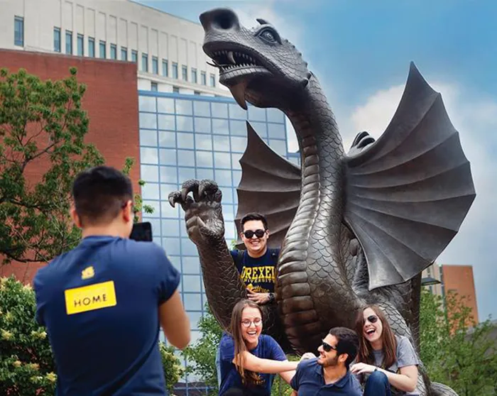 Students take pictures on the Drexel Dragon at Drexel University.