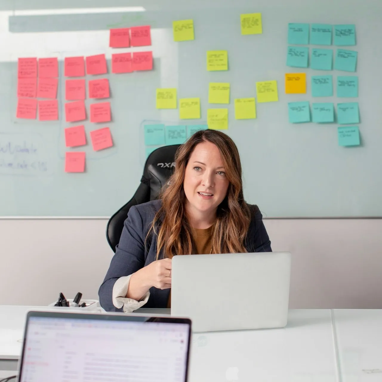 Higher Ed marketing strategist leading a CTV ad planning session with sticky notes on whiteboard